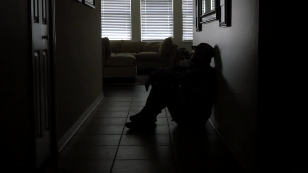 Lonely soldier silhouette sitting in dark hallway, WIDE, 4K — Stock Video