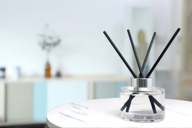 Asgari tasarım dekorasyon odasındaki beyaz mermer masada sabahları rahatlamak ve romantik ortam yaratmak için oda spreyi olarak kullanılıyor. 