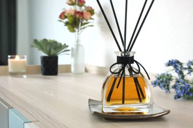 Yatak odasındaki ahşap masada oda spreyi olarak kullanılıyor. Sevgililer Günü 'nde çiçeklerin arka planında romantik bir ortam yaratmak ve rahatlamak için.