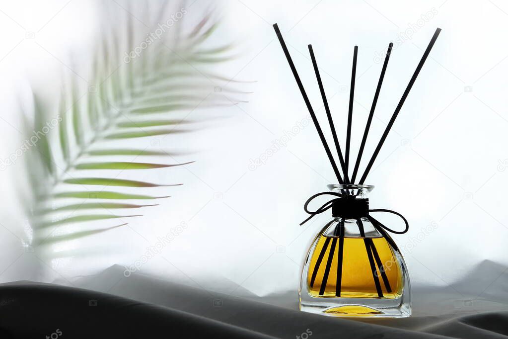 luxury aroma scent reed diffuser glass bottles are on the table with table runner to creat romantic and relax ambient in the bedroom with white wall background in the morning for happy valentine day