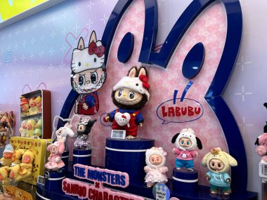 art toys Labubu key chain collection from Pop Mart blind box collectable cute toys display on nice shelf background at Pop mart flagship store during new release promotion event labubu macaron doll