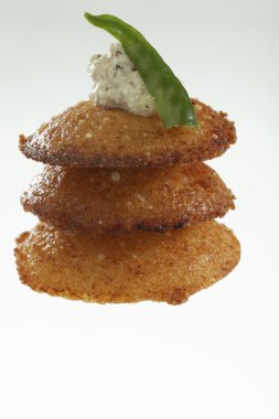 South Indian fast food fried idly  with coconut chutney. clipart