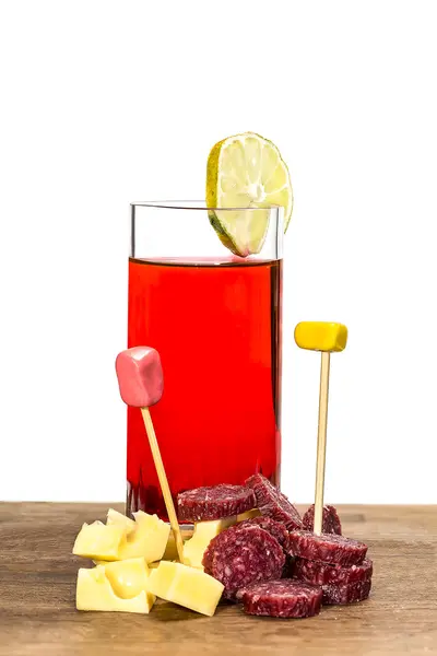 Glass of red vermouth with cheese and salami — Stock Photo, Image