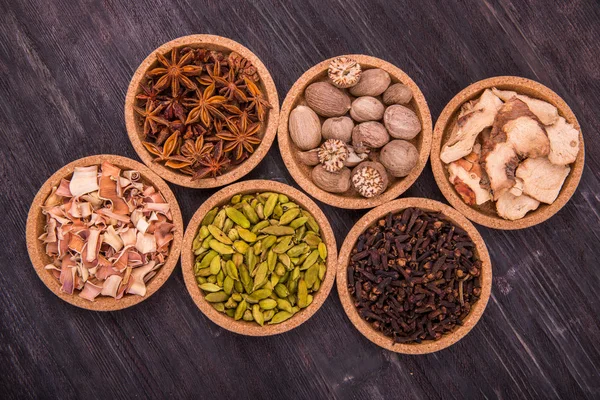 Spices in round forms on a dark wooden background — Stock Photo, Image