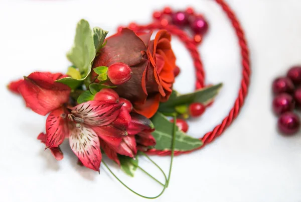 A wedding red buttonhole with irises and a cord — Stock Photo, Image