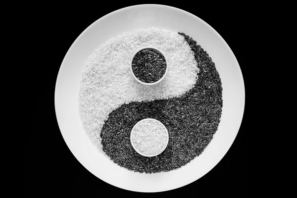 Yin Yang from grains on a black background