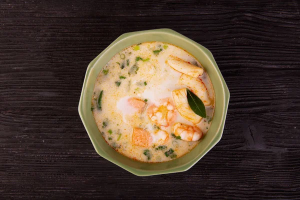coconut milk soup with seafood and lime leaves