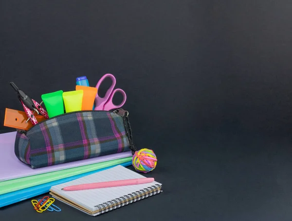 Pencil case full of school supplies. School Building, black Background, Felt Tip Pen, Childhood..