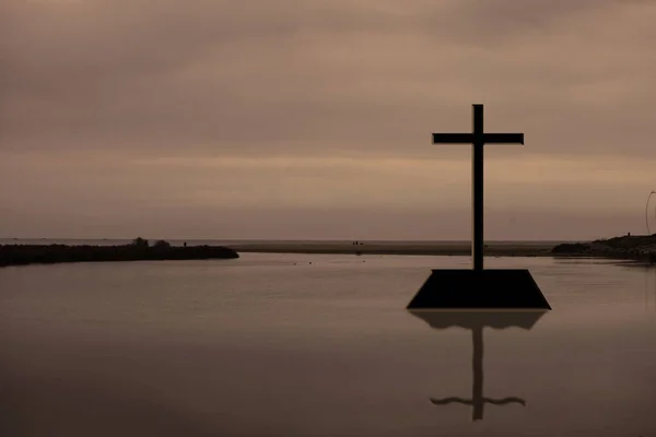 cross on river landscape, Jesus Christ cross symbol on a water sky , Christian religion resurrection concept