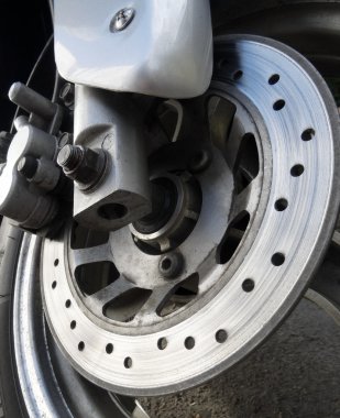 Wear brake disc on the front wheel of motorcycle  clipart