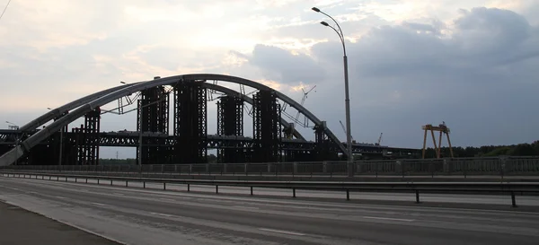 Construction of steel arch bridge over river — Stock Photo, Image