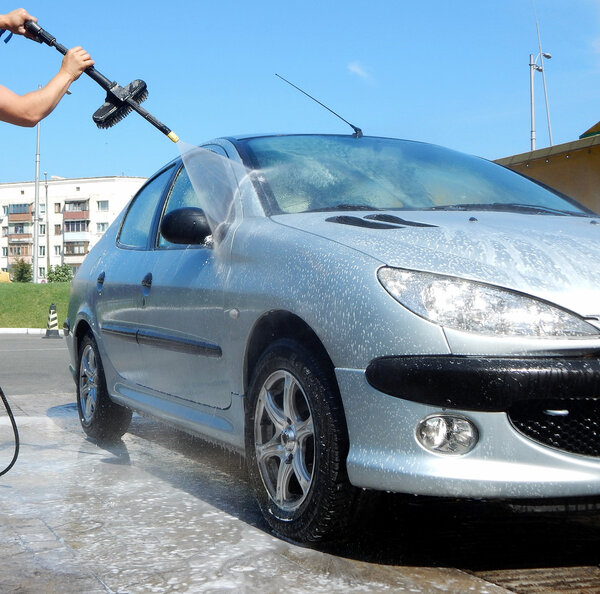 High pressure jet washer in process of car washing