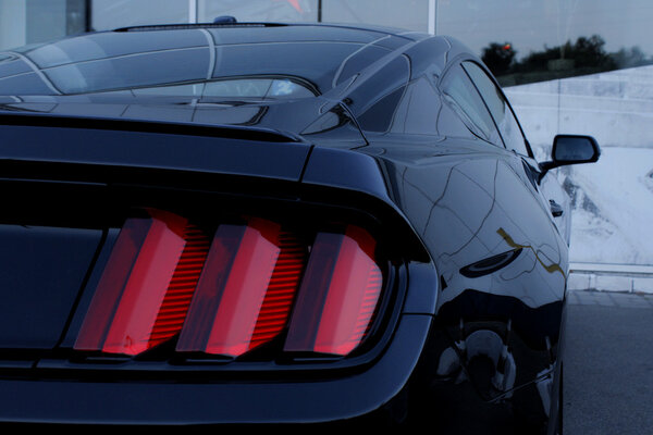 Back side and rear lights of black sport car