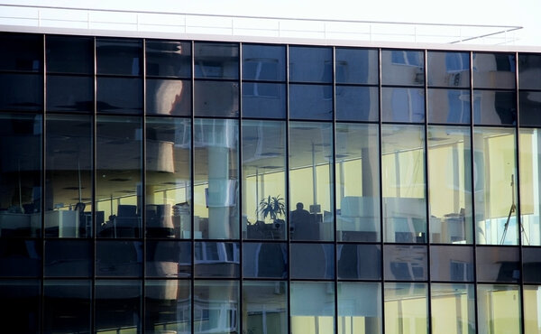 Business building with office work places behind the panoramic windows