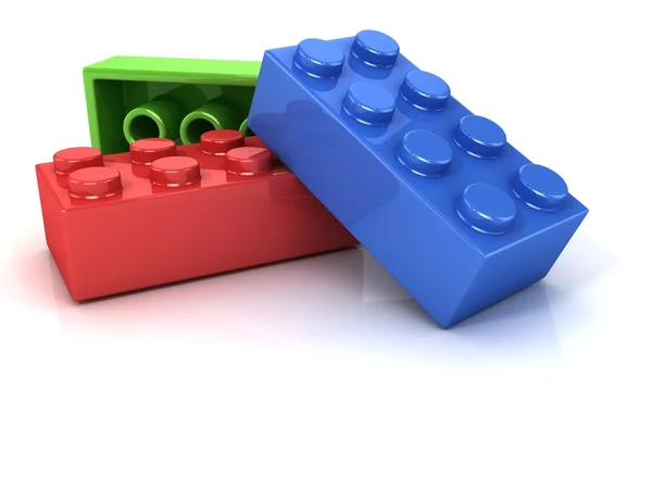 Plastic bouwstenen, kinderen speelgoed geïsoleerd op witte achtergrond — Stockfoto