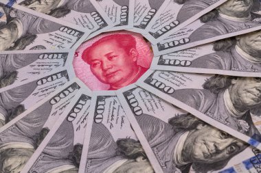 100 dolarlık banknotların ortasında Başkan Mao 'nun portresi olan 100 Yuan banknotun bir parçası.