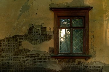 Eski bir evin penceresi ve zaman zaman yıkılan bir duvar.