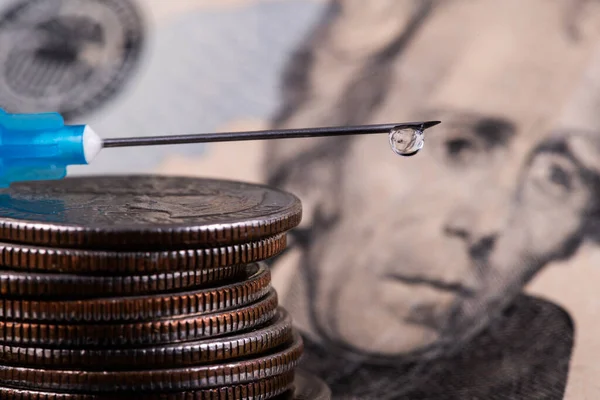 Disposable Syringe with Drop on the Point of a Needle, American Coins and 20 American Dollar Bill