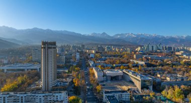 Almaty, Kazakistan 'ın merkez kısmının insansız hava aracı görüntüsü, Kazakistan Oteli ile birlikte Trans-Ili Alatau Dağları' nın tepesinde bir sonbahar sabahı.