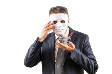 Beyaz maske takan orta yaşlı bir işadamı elinde küçük bir süpermarket arabası tutuyor..