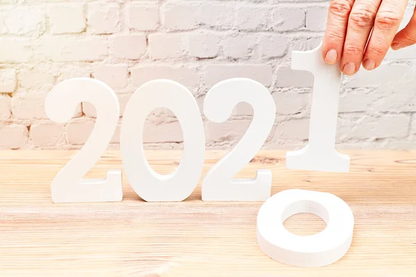 Woman Changing 2020 for 2021 with her hand. Happy New Year concept.