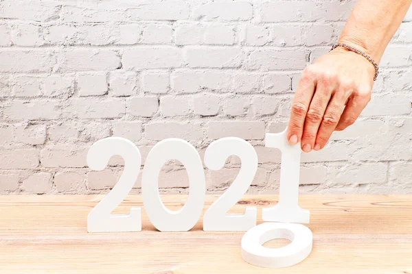 Woman Changing 2020 for 2021 with her hand. Happy New Year concept.