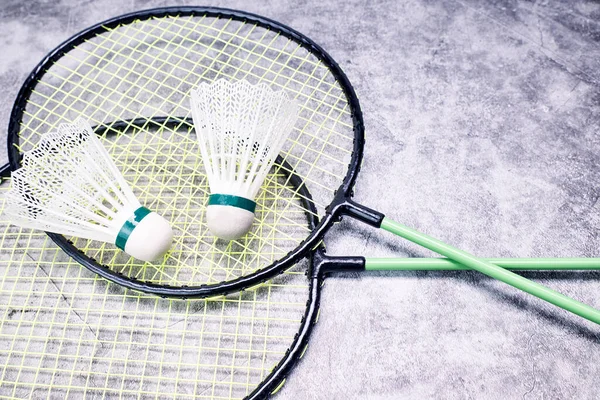 Two shuttle cock badminton and two racket. Indoor sports concept