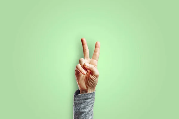 Woman Arm Making Victory Gesture Hand Isolated Green Background Gesture — Stock Photo, Image