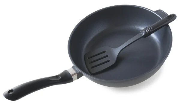 Frying pan and plastic paddle — Stock Photo, Image