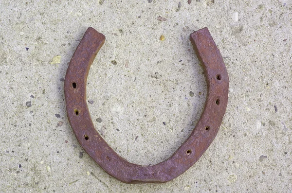 Horseshoe on the concrete — Stock Photo, Image