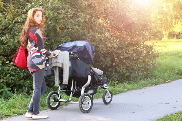 Walk women with stroller summer sunlight — Stock Photo, Image