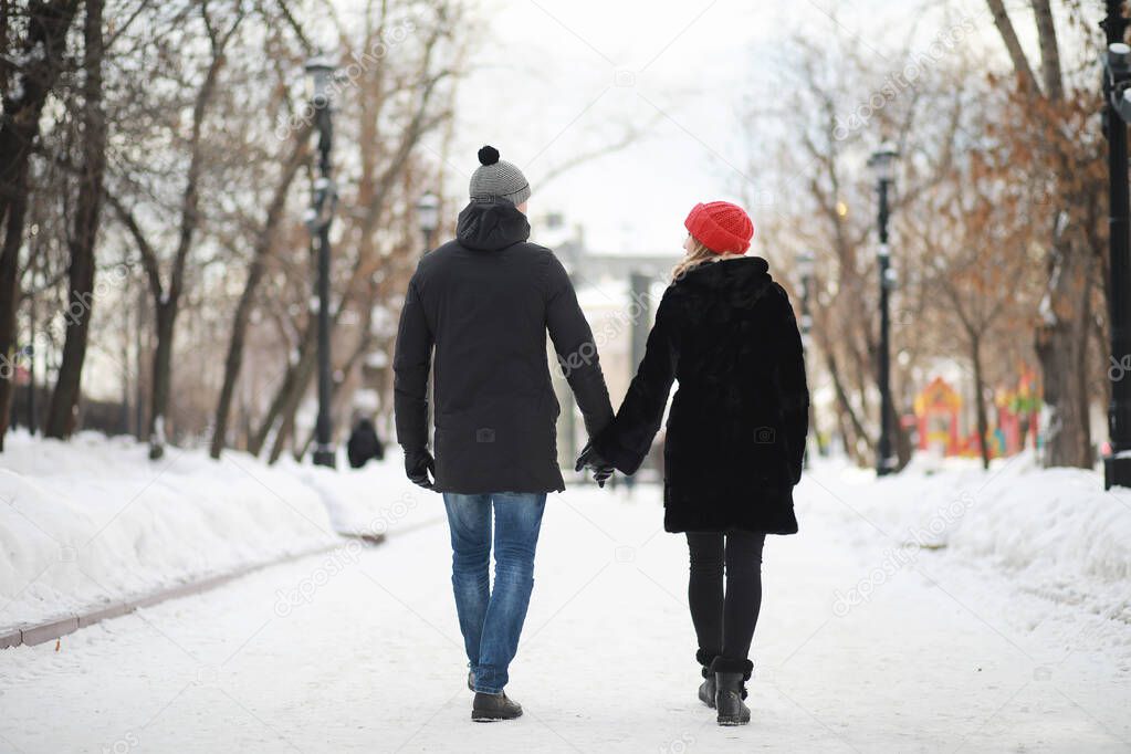 Young couple walking through the winter city