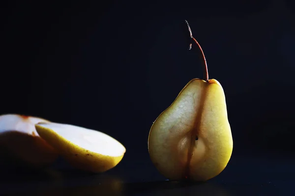 Pear slices on a black background.pears in a plate and slices of pears top view.