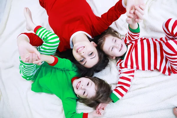 Family Striped Pajamas Resting Home Little Children Dressed Elves Lying — Stock Photo, Image