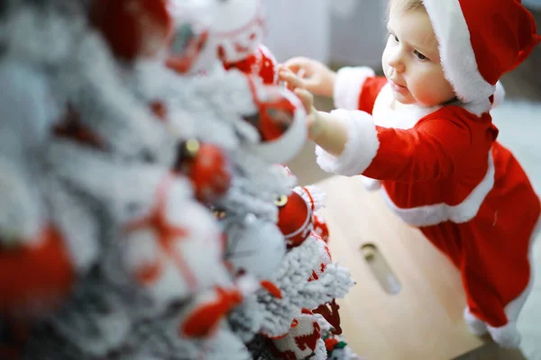 Merry bright christmas. Lovely baby enjoy christmas. Childhood memories. Santa girl little child celebrate christmas at home. Family holiday. Girl cute child cheerful mood play near christmas tree.