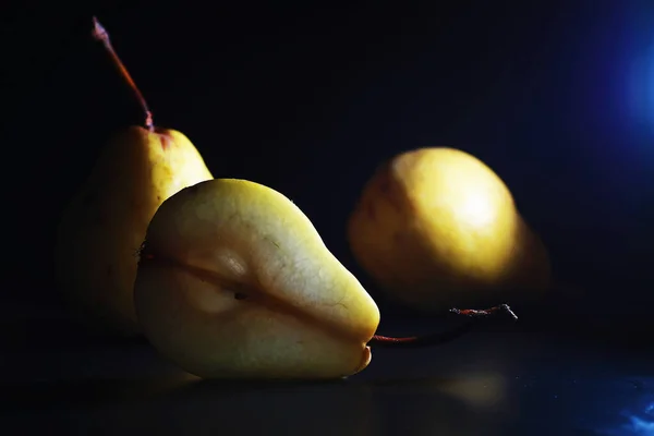 Pear slices on a black background.pears in a plate and slices of pears top view.