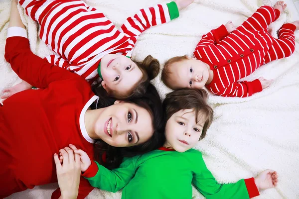 Family Striped Pajamas Resting Home Little Children Dressed Elves Lying — Stock Photo, Image