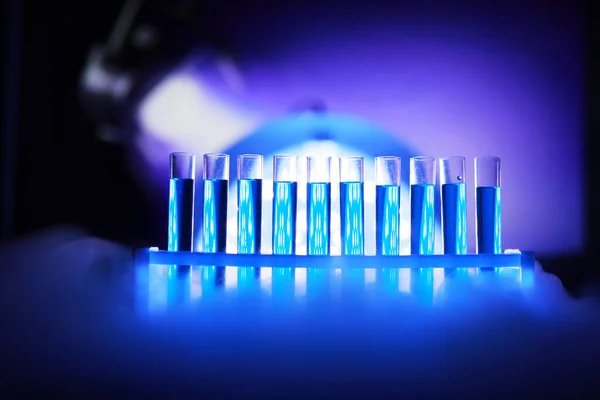 Test tube of glass overflows new liquid solution potassium blue conducts an analysis reaction takes various versions reagents using chemical pharmaceutics cancer manufacturing