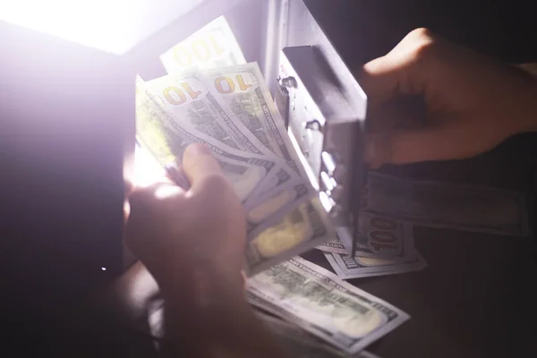 Steel safe with money. Hand putting password in the safety money box in hotel room