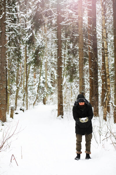 Outdoor portrait of handsome man in coat and scurf. Casual winter fashion