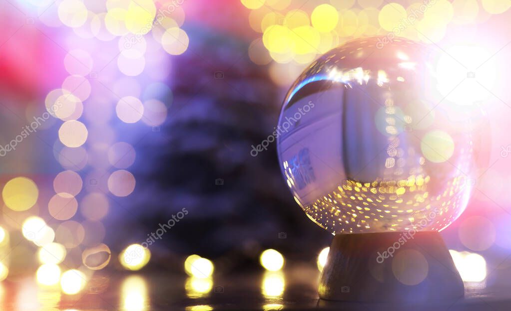 Crystal Ball on the floor with bokeh. Glass ball with colorful bokeh light, new year celebration concept.