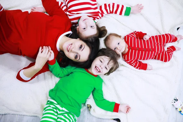 Family Striped Pajamas Resting Home Little Children Dressed Elves Lying — Stock Photo, Image