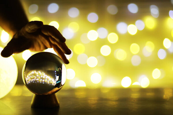 Crystal Ball on the floor with bokeh. Glass ball with colorful bokeh light, new year celebration concept.