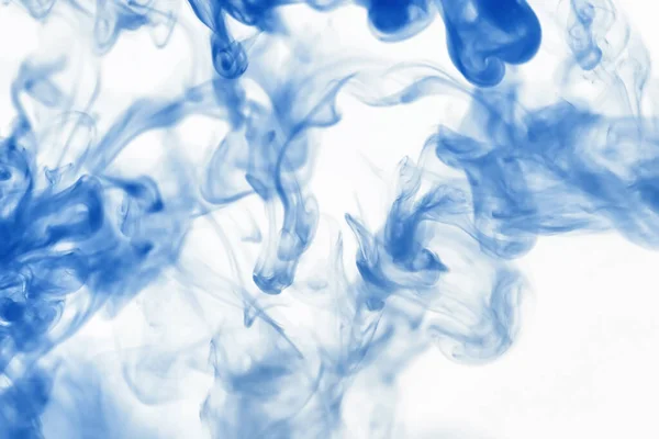 Puffs of paint in water. The dissolution of dye in water. Water pollution. Concept art creativity.