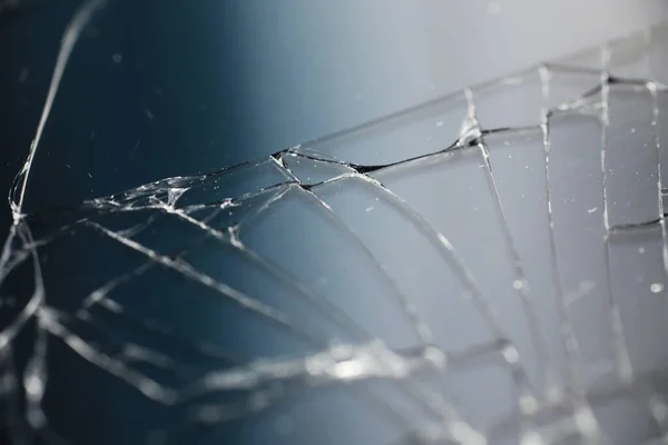 Crack on the glass. Broken screen. Broken phone. Cracked glass background. White cracks in glass.