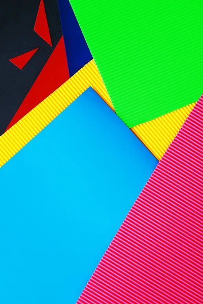Sheets of colored paper, iridescent palette of colored paper, rainbow colors. Top view table with colored paper and scissors.