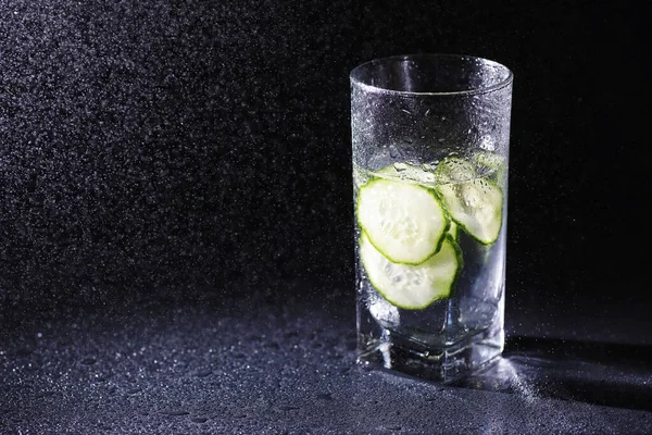 Cucumber water. Drinking water with fresh cucumber. Mineral water. Healthy mineral refreshing water with cucumber.