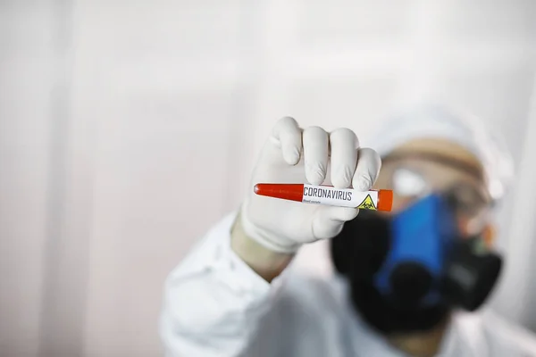 A scientist researcher in the laboratory is testing drugs for treatment of viral pneumonia. Coronovirus blood test of infected patients. World pandemic.