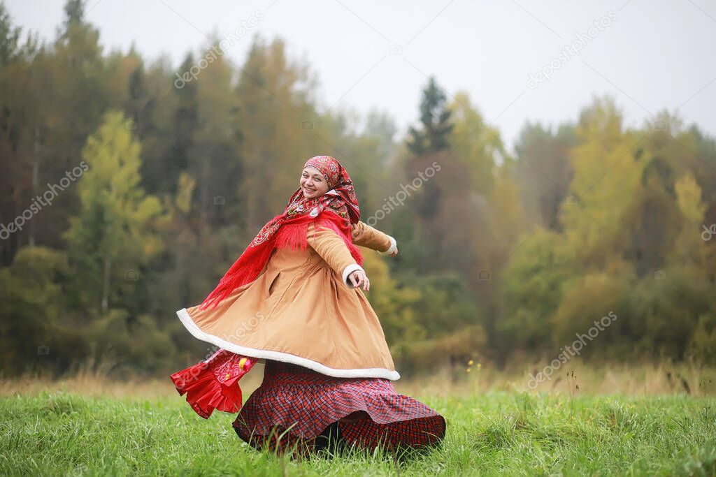 Traditional Slavic rituals in the rustic style. Outdoor in summer. Slavic village farm. Peasants in elegant robes.