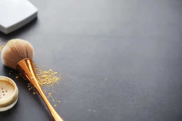 Powder and makeup brush. Brown powder on background. Makeup products. Style concept.